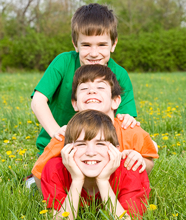 Three happy kids playing outdoors