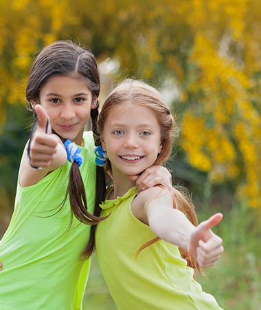 Two kids with a thumbs up